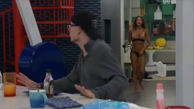 Angela entering room in tan bikini
