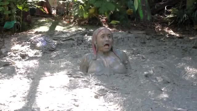 Girl Jumps in The Mud