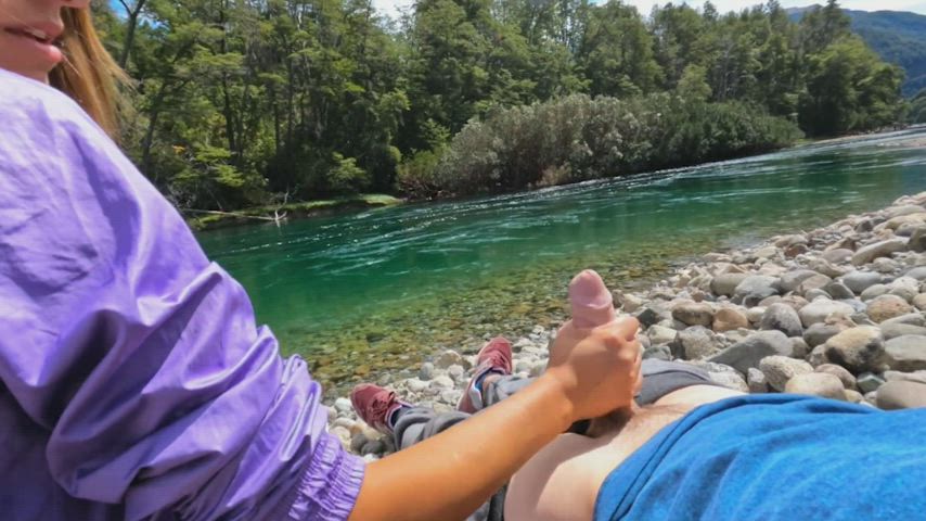 Handjob in the great outdoors by a flowing river