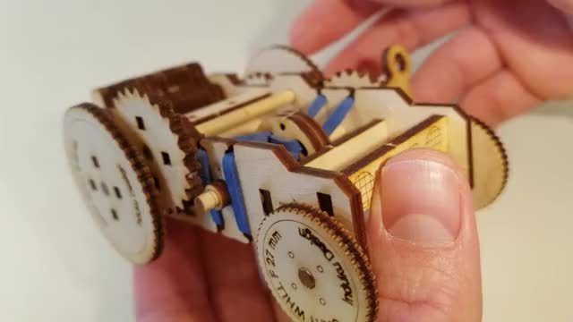 A rubber band driven, wind up, laser cut plywood car.