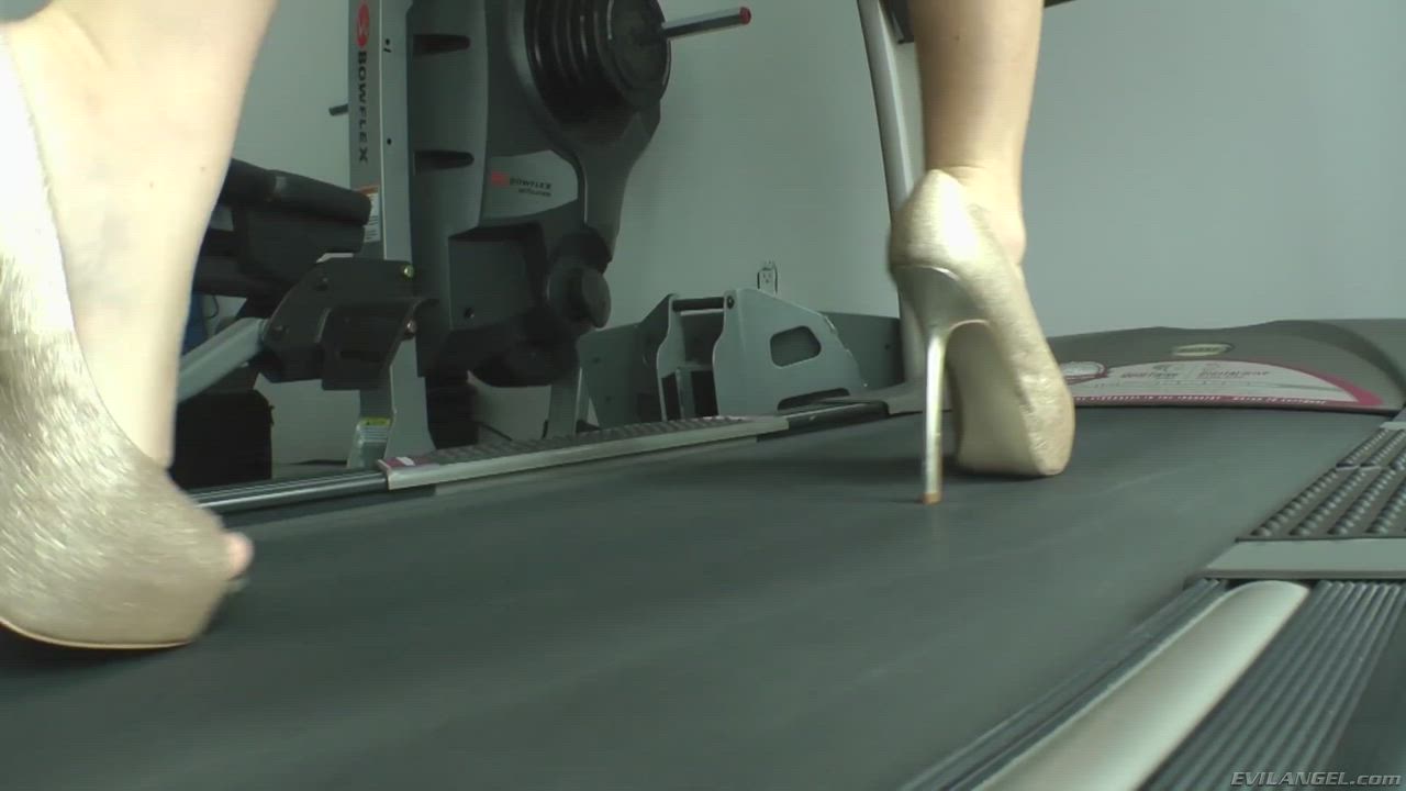 Sophie Dee on a treadmill wearing heels and a dirndl