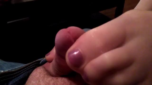 She grips the tip with her toes while stroking