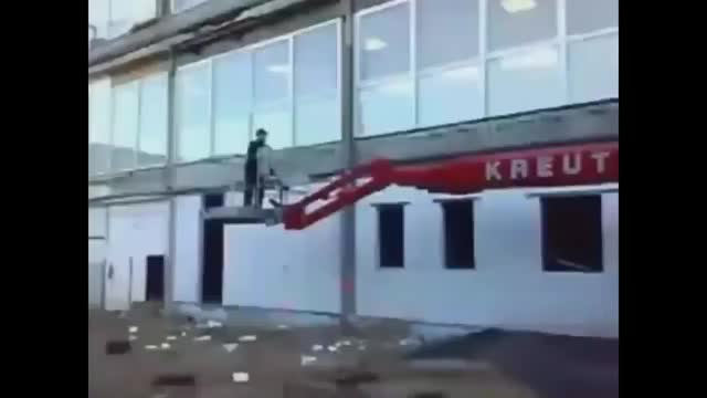 Textbook example of How Not To move a boom lift...