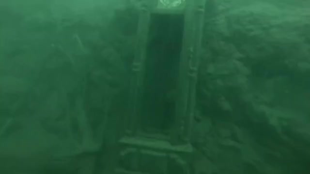 Divers find creepy statue and Grandfather Clock in a popular lake