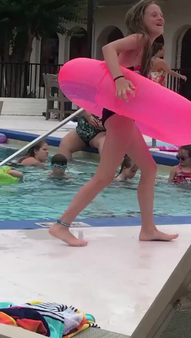 Lady shaves legs in hotel pool