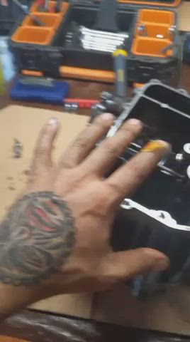 Tattooed mechanic hands