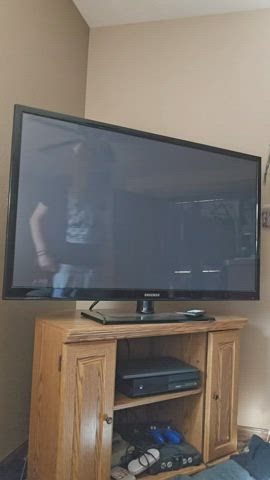 Caught changing in the TV reflection