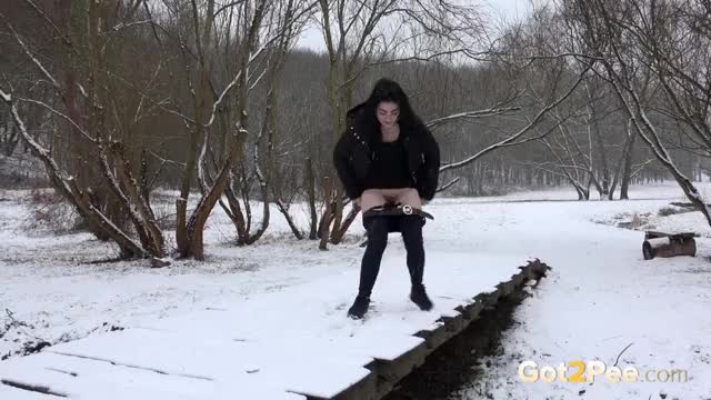 European dark haired cutie melting the snow with her warm pee - See full video at