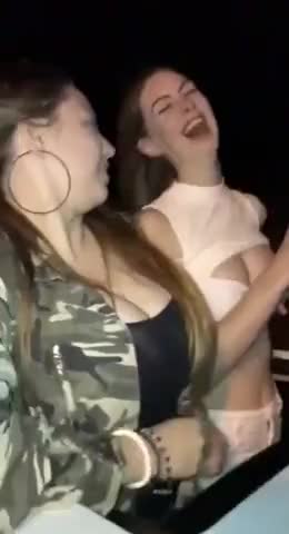 Two girls ride roller coaster and show their tits