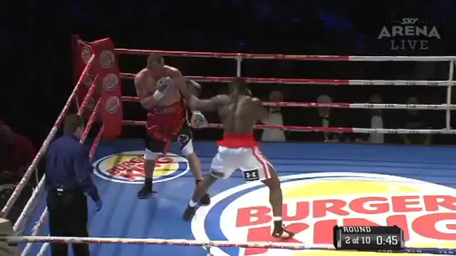 Izu Ugonoh knocks Will Quarrie out of the ring onto someone's dinner table.