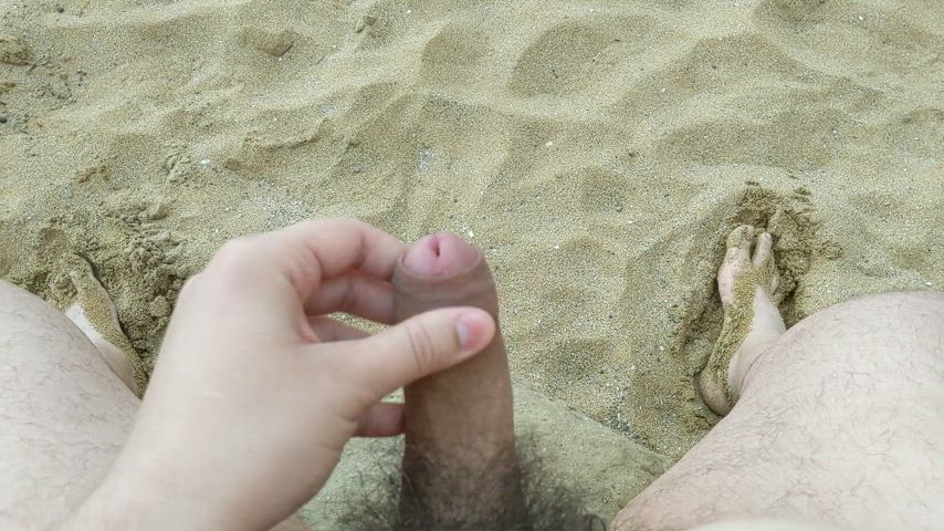 Cumming on a rock at the beach