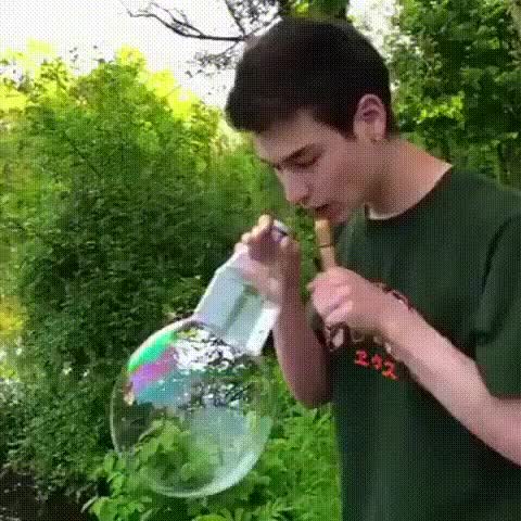 Blowing colored smoke bubbles