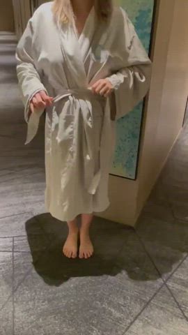 Taking off bathrobe in the hallway