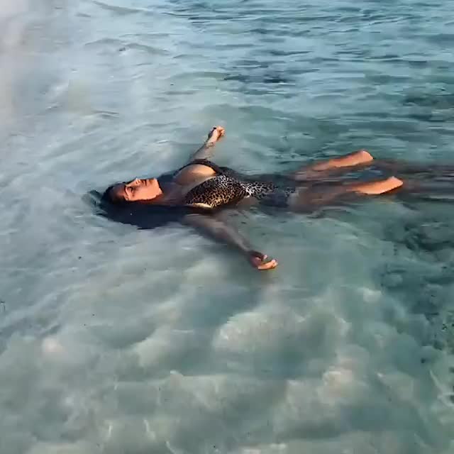 Salma Hayek relaxing in the ocean (s)