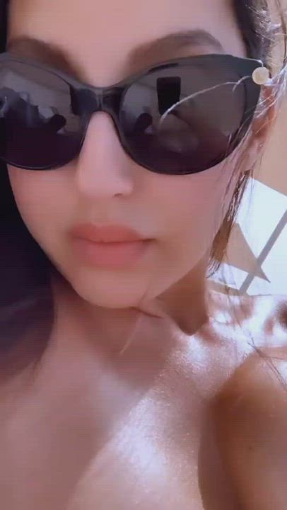 Oily big titties of Nora Fatehi in a black bikini with lips looking like it will