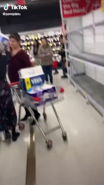 Karen with a cart full of toilet paper fights with a senior for another pack