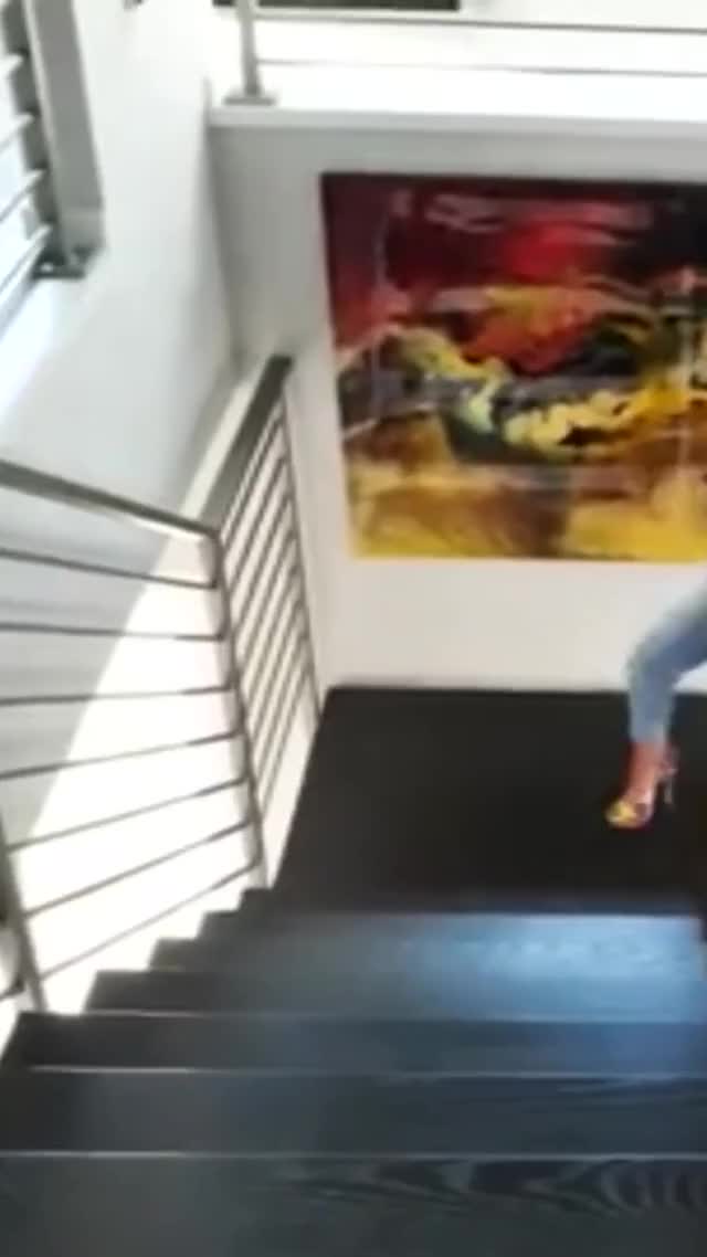 Curvy and busty Ava Adams walking up stairs