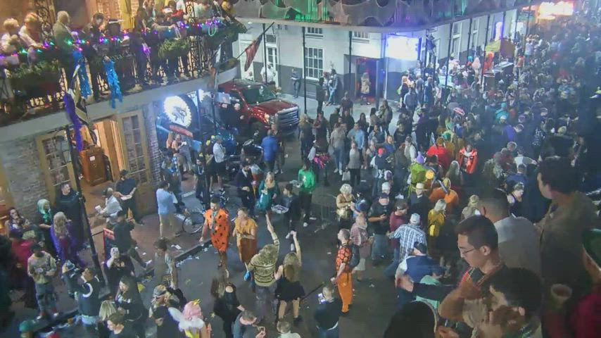 Woman in costume flashes boobs multiple times from multiple angles on bourbon street