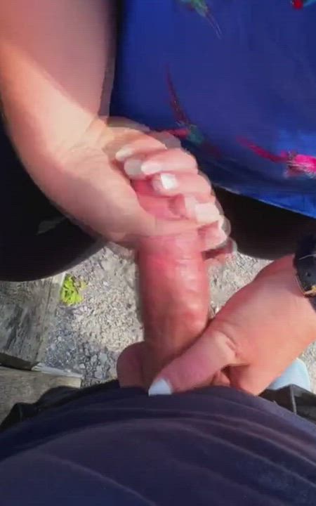 Handjob by the lake with people going by
