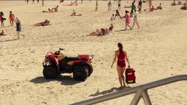 Alexandra Daddario - Baywatch - in red swimsuit on beach (w/ backstory), being observed