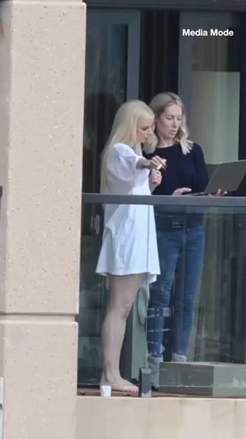 Anya Taylor-Joy smoking on her hotel room balcony 