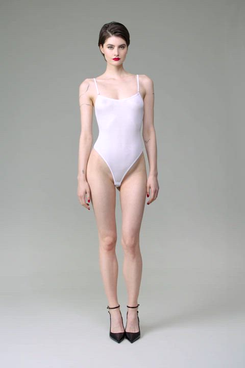 Anastasia Jovanovic in white La Femme Amazone thong bodysuit w/ straps, by Maison