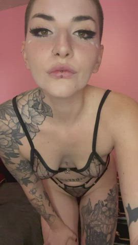 Pierced nipples and a shaved head
