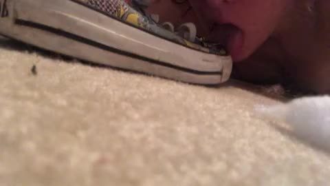 Filthy slut licking shoe and putting it in mouth.