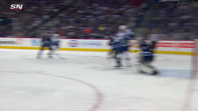 Hellebuyck gets cut near his eye from the stick of his own teammate Morrissey.