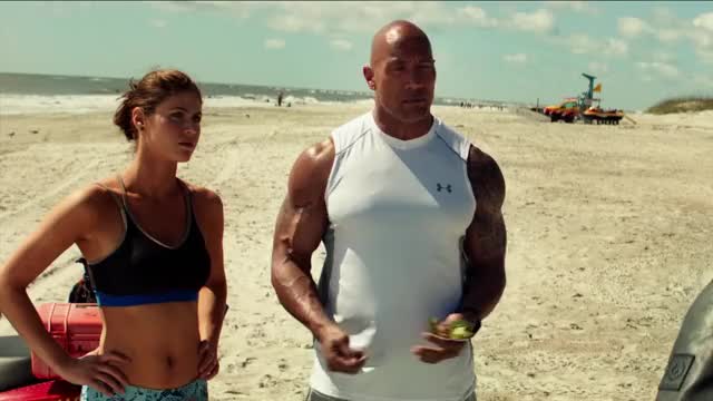Alexandra Daddario - Baywatch - in sports bra on beach, talking to Zac Efron and
