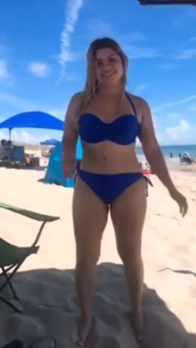 really sexy girl dances on the beach in her blue bikini