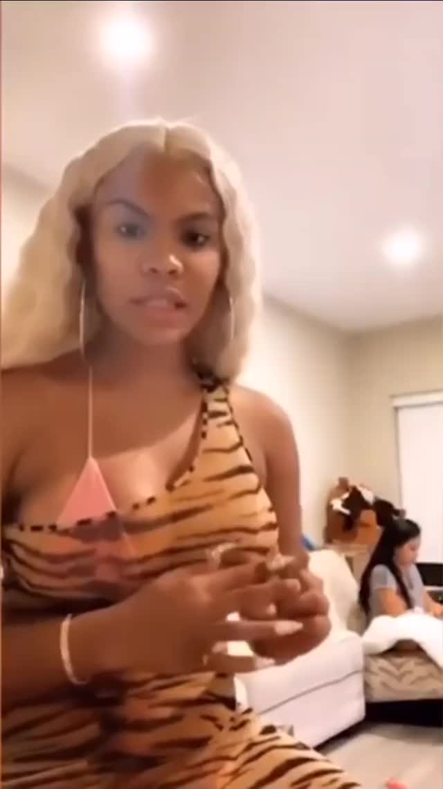 Sexy chocolate Chinese kitty dancing in tight tiger dress