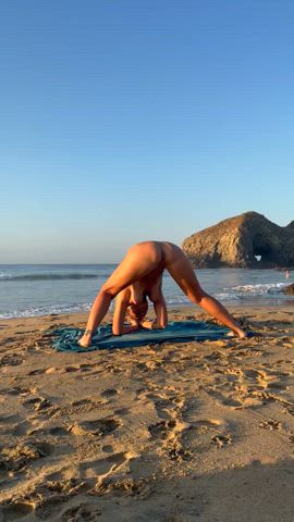 Naked handstand on beach 