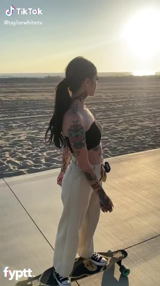 Flashing her tits on the beach ?