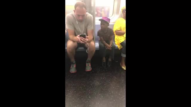 A good man gave his phone to a little boy to play his favorite game