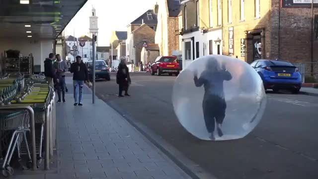 Woman 'self-isolating' in ZORB BALL leaves shoppers bemused as she rolls around supermarket