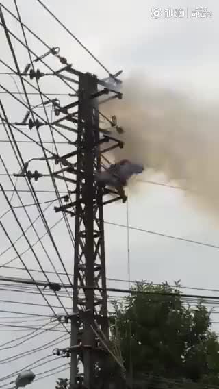 Man being burned on power line tower