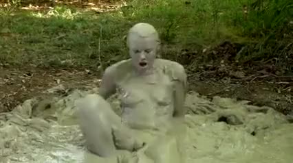 Naked Sativa bathing in mud