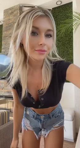 This blue eyed blonde looks great in her black snap button crop top and jean shorts