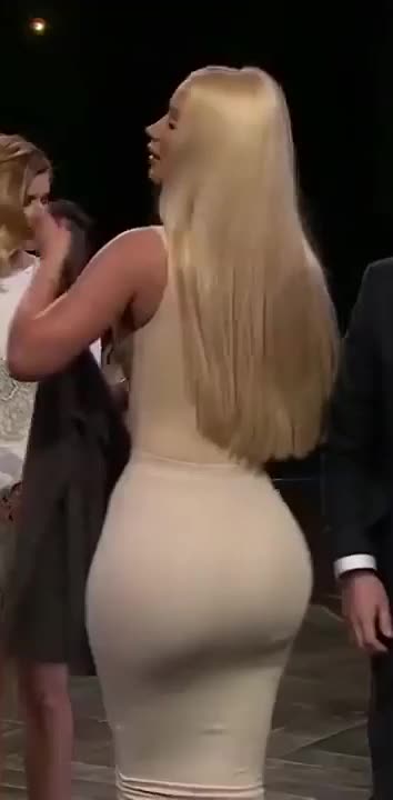 Iggy Azalea in a tight-fitting dress.