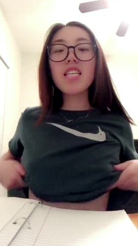 Cute Japanese girl with glasses flashes her tits