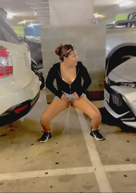 Filipina Monica standing pee in public between cars In parking garage