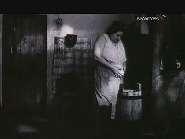 Mother trying to feed her son. From the movie "And the wind returneth"