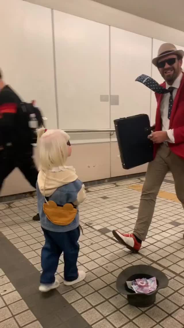 a sweet little girl and the street performer