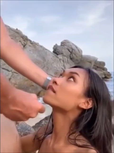 Hot Asian girl gets a mouthful at the beach 