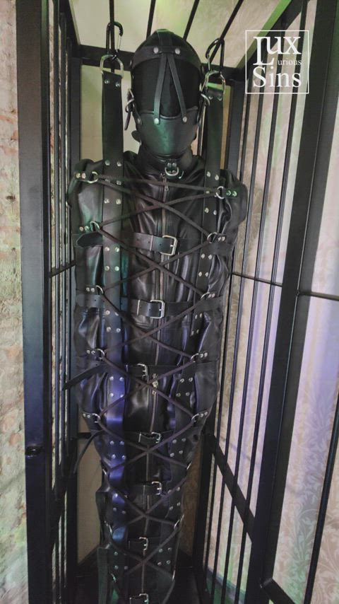 Bound in the leather sleepsack and restrained in the cage [m]