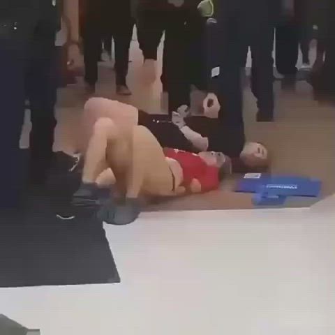 Two girls protesting getting removed from shopping mall