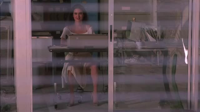 Jennifer Connelly - The Hot Spot (1990) - opening & showing off legs (in pulled
