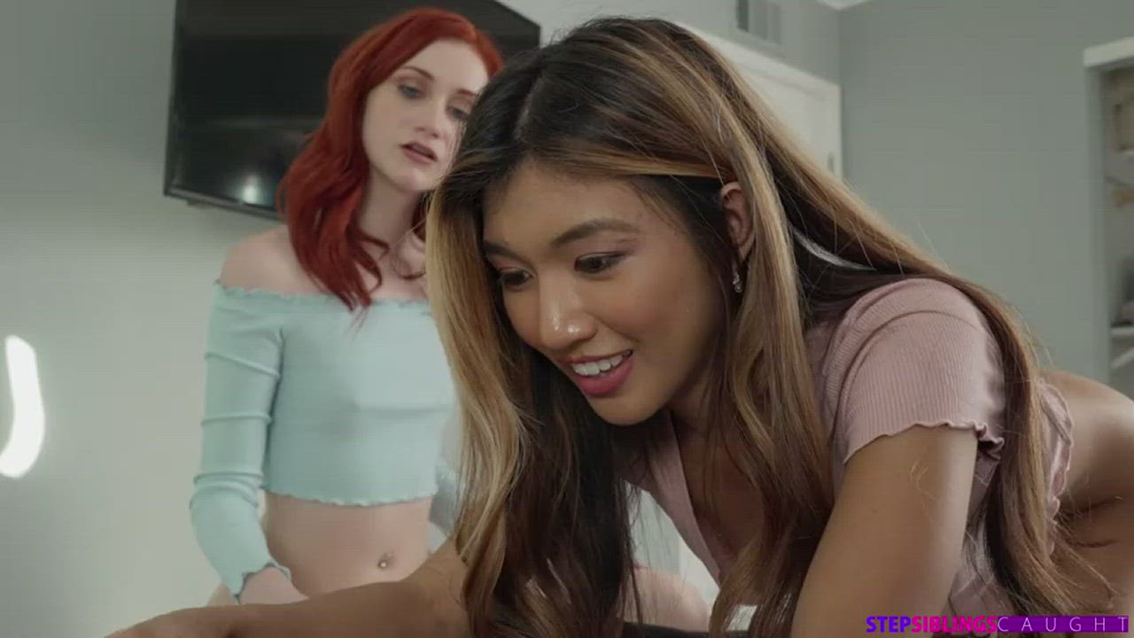 Redhead and Asian friend blowing