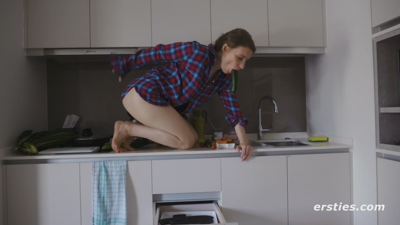 Fucking her own ass on her counter.